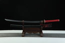 A close-up view of Moonswords Kafuun Katana, with a red handle, featuring intricate designs and patterns.