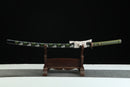 A close-up view of Moonswords Kyochiku Katana, with a green handle and white accents, featuring intricate designs and patterns.