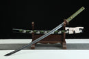 A close-up view of Moonswords Kyochiku Katana, with a green handle and white accents, featuring intricate designs and patterns.