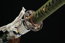 A photo of Moonswords Kyochiku Katana with a silver and gold-gilded bronze guard, is shown against a dark background.