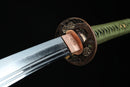 A photo of Moonswords Kyochiku Katana with a silver and gold-gilded bronze guard, is shown against a dark background.