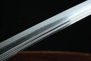 A close-up view of a Clay-tempered Tamahagane Steel blade against a dark background.