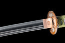 A close-up view of Moonswords Kyochiku Katana with Hamon on the blade and intricate brown and gold designs on the handle.