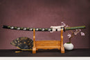 A close-up view of Moonswords Kyochiku Katana, with a white handle and green accents, featuring intricate designs and patterns.