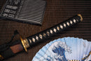 A close-up view of Moonswords Ghost of Kyoyu Katana with bronze guard, black handle and black shealth.