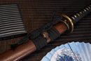 A close-up view of Moonswords Kyoyu Katana with bronze guard, black handle and black shealth.