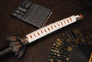 A close-up view of Moonswords Black Mortal Blade Odachi with bronze guard, white handle and black shealth.
