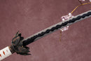 A close-up view of a Damascus steel blade against a textured background