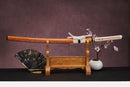 A close-up view of Moonswords Nichirin Katana, with a white handle and orange accents, featuring intricate designs and patterns.