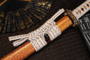 A close-up view of Moonswords Nichirin Katana with orange shealth.