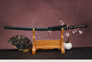 A close-up view of Moonswords Ryokuya Ichirin Katana, with a black handle and white accents, featuring intricate designs and patterns.