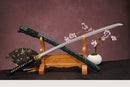 A close-up view of Moonswords Ryokuya Ichirin Katana, with a black handle and white accents, featuring intricate designs and patterns.