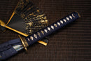 A close-up view of Moonswords Shuen no Bara Katana with bronze guard, deep blue handle and blue shealth.