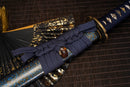 A close-up view of Moonswords Shuen no Bara Katana with bronze guard, deep blue handle and blue shealth.