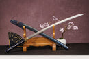 A close-up view of Moonswords Shuen no Bara Katana, with a deep blue handle and white accents, featuring intricate designs and patterns.