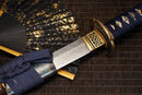 A close-up view of Moonswords Shuen no Bara Katana with Hamon on the blade and intricate deep blue and gold designs on the handle.