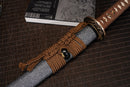 A close-up view of Moonswords Shunsho Katana with bronze guard, brown handle and grey shealth.