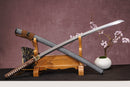 A close-up view of Moonswords Shunsho Katana, with a brown handle and white accents, featuring intricate designs and patterns.
