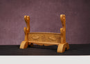 Decorative wooden stand with carvings on a dark surface and purple background