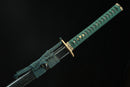 A close-up view of Moonswords Suihyou Katana with bronze guard, green handle and black shealth.