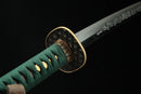A photo of Moonswords Suihyou Katana with a gold-gilded bronze guard, is shown against a dark background.