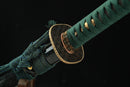 A photo of Moonswords Suihyou Katana with a gold-gilded bronze guard, is shown against a dark background.
