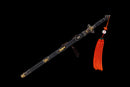 The Qianqing sword in a black shealth against a black background