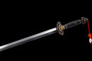 A close up of the Qianqing Sword against a black background