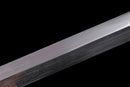 A close-up of the Hand-Forged Laminated Steel blade on the Qianqing sword against a black background