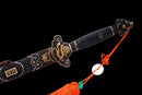 Close up of the Qianqing sword in a black shealth against a black background