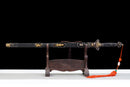 The Qianqing sword in a black shealth on a wooden stand against a black background