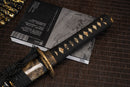 A close-up view of Moonswords Toga Wakizashi with bronze guard, black handle and shealth wrapped in real rayskin.