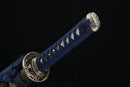 Sword with blue scabbard and gold decorative elements on a black background