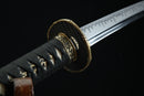 A close-up view of a traditional Japanese sword, showcasing its intricate design and craftsmanship.