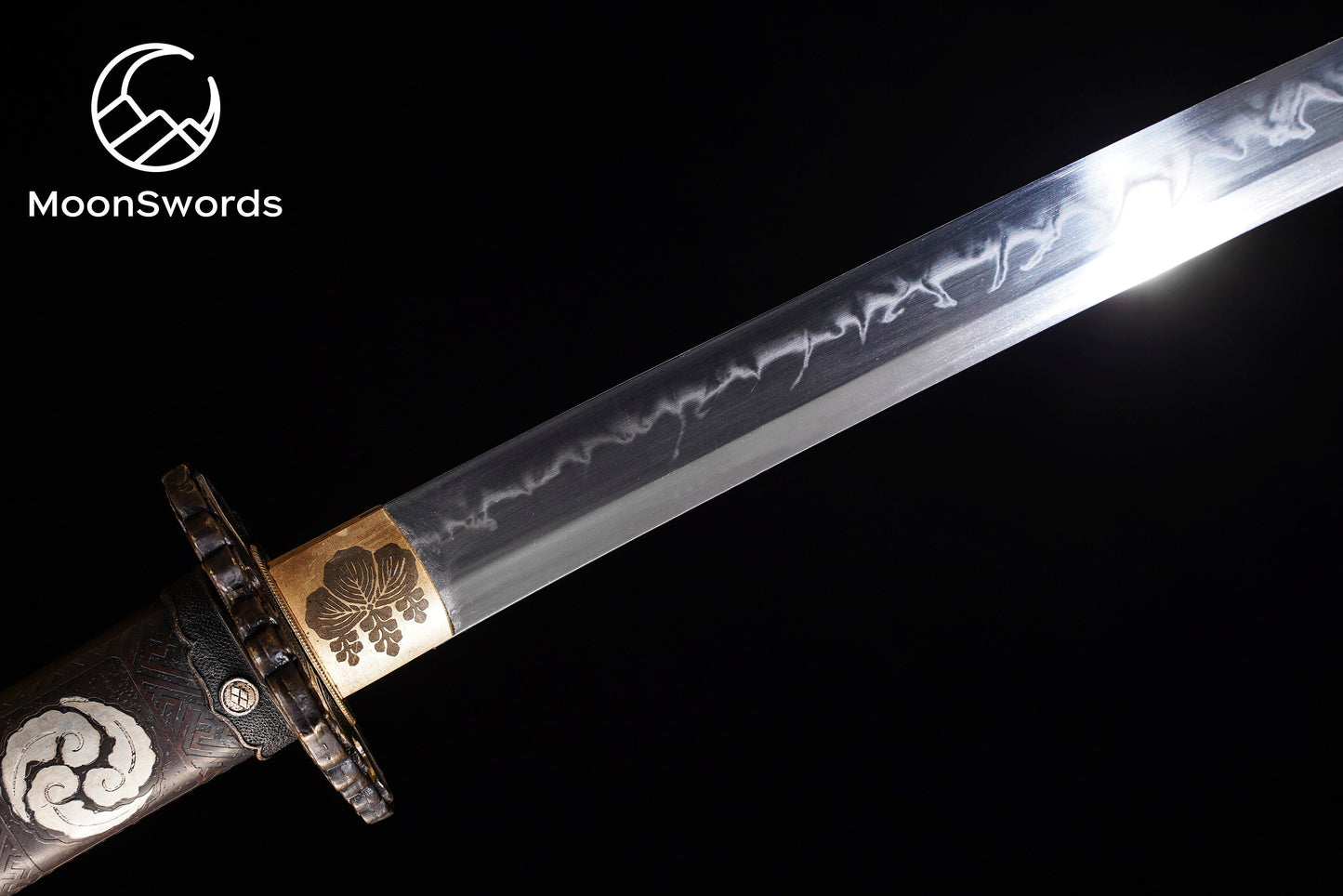 a sword with a gold and silver decoration on it