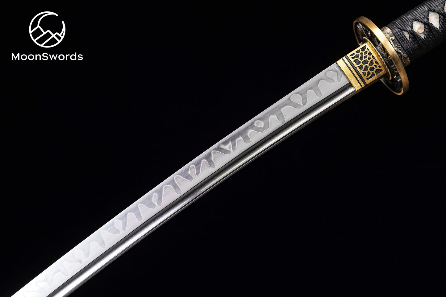 a sword with a gold and silver handle on a black background