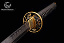 a close up of a gold and black sword