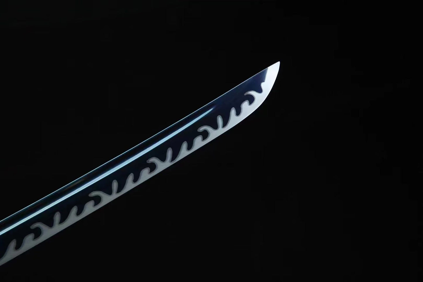 a knife with a black handle on a black background