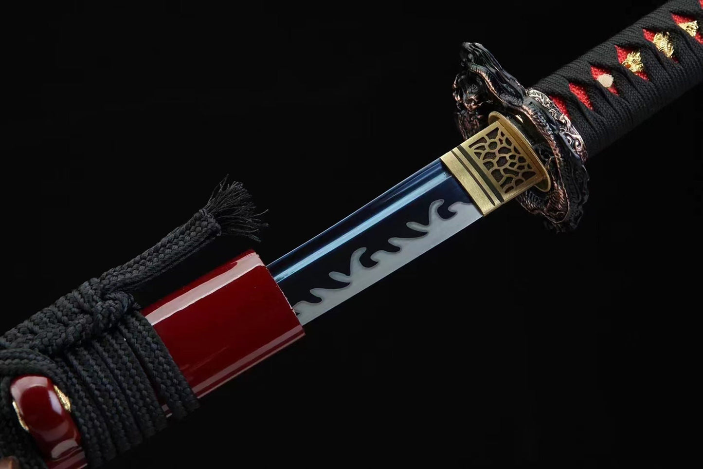a close up of a red and black samurai sword
