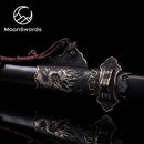 a close up of a metal object on a black surface