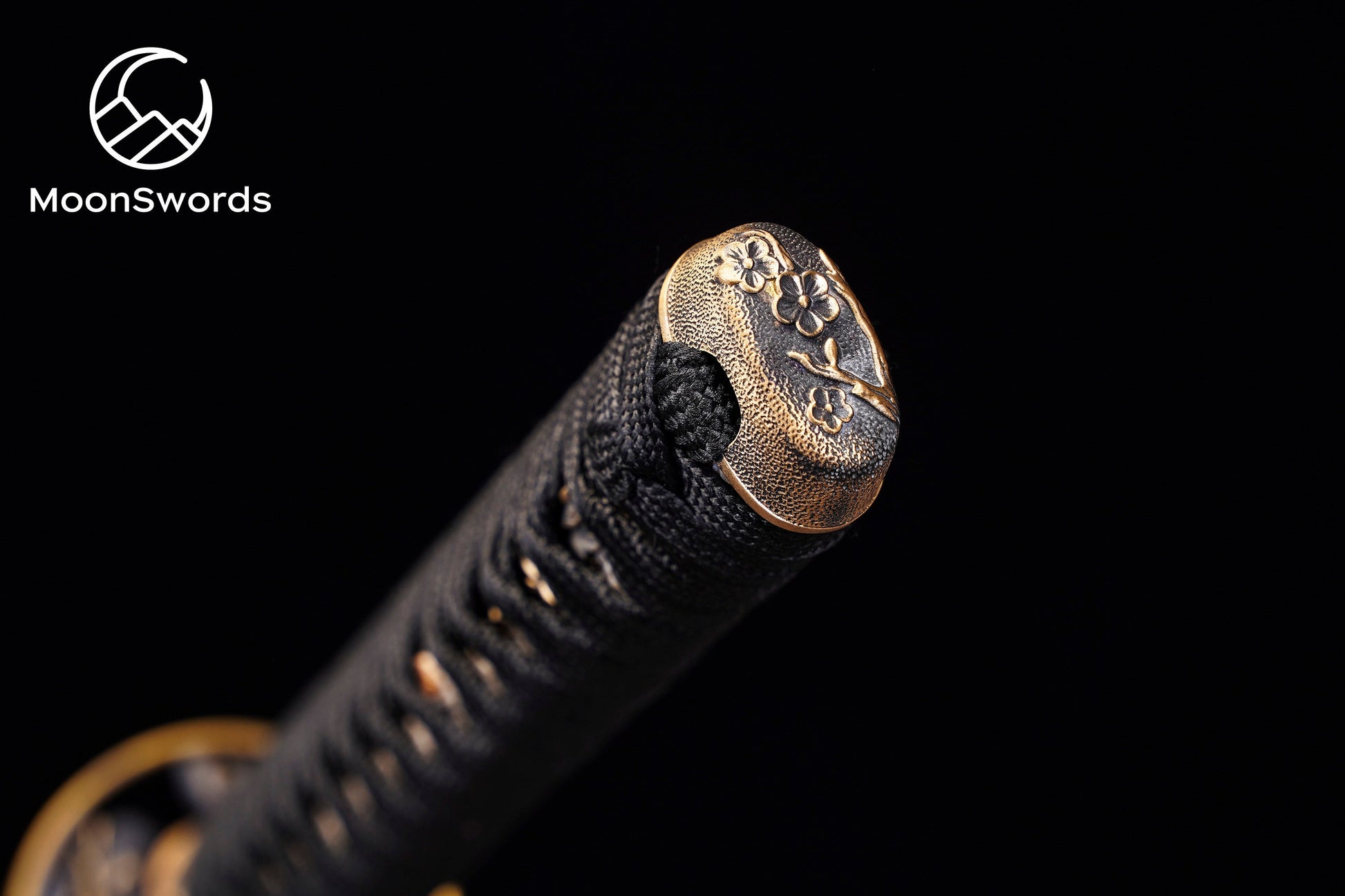 a close up of a metal object on a black background