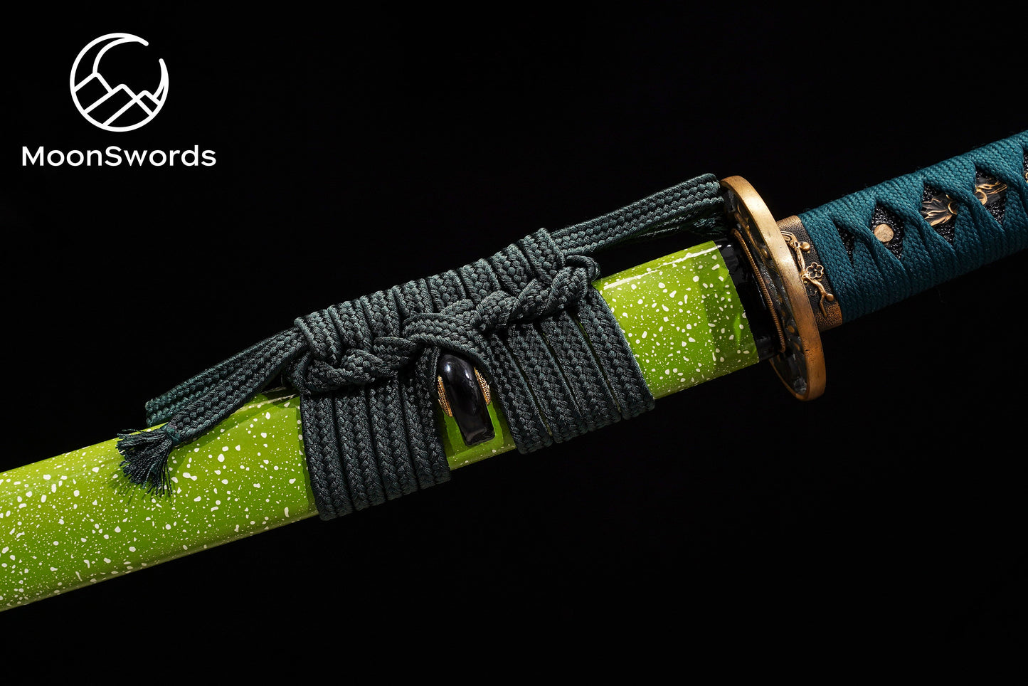 a close up of a knife with a green handle