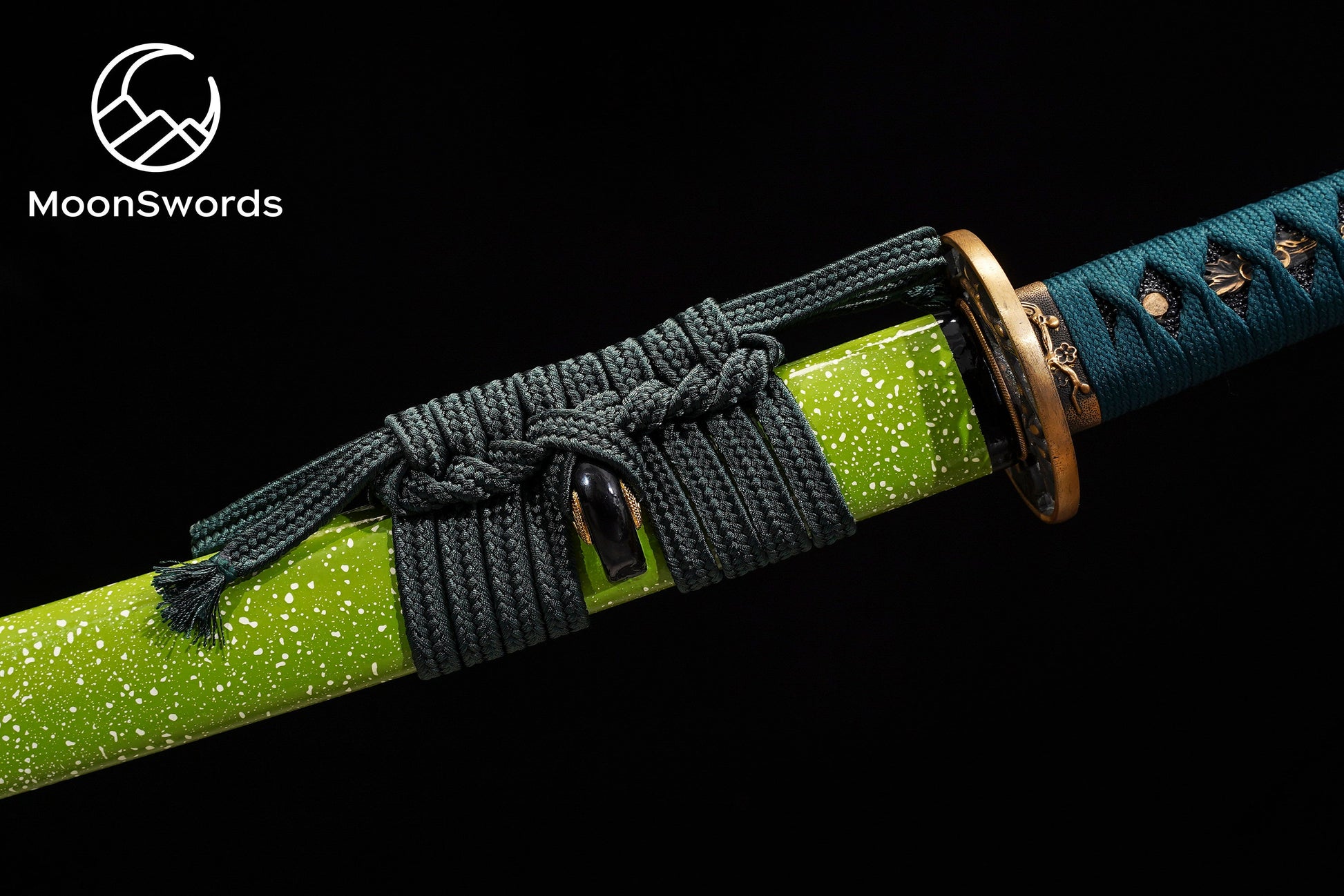 a close up of a knife with a green handle