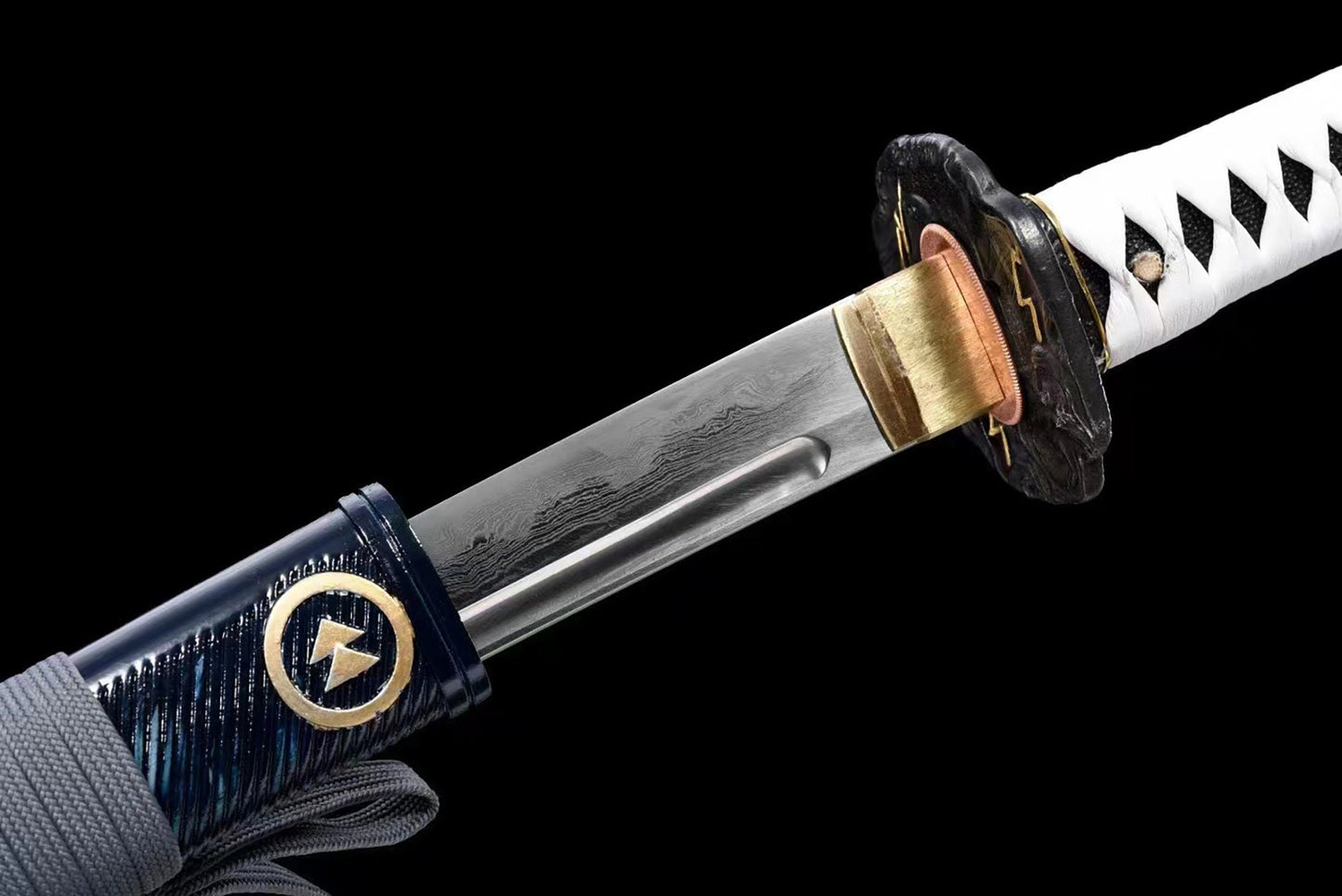 a close up of a knife with a black handle