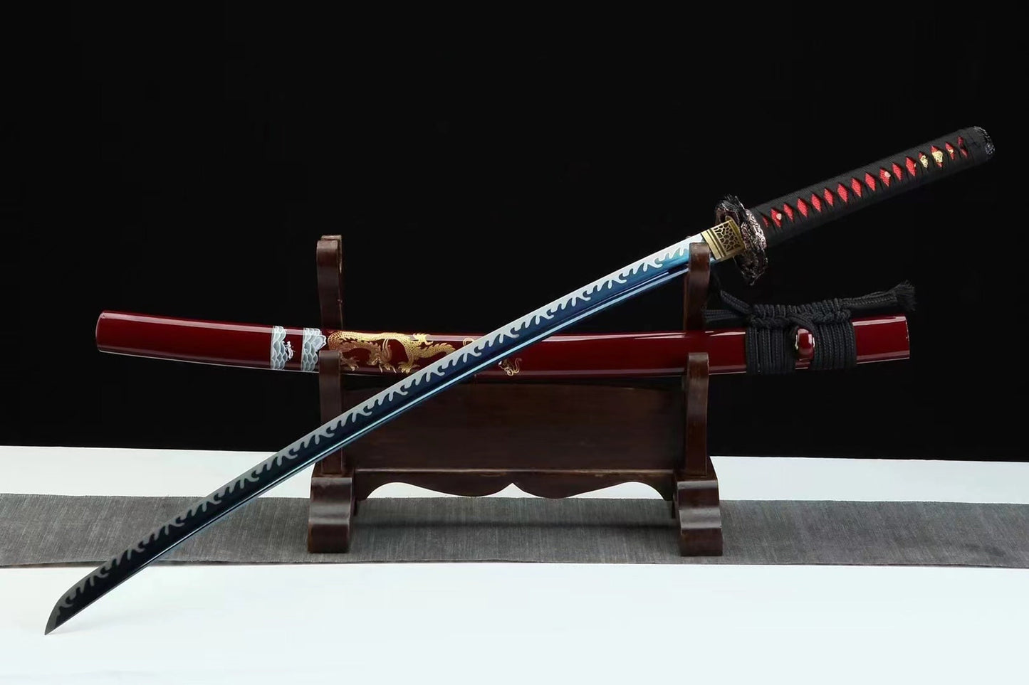 a sword with a wooden stand on a table