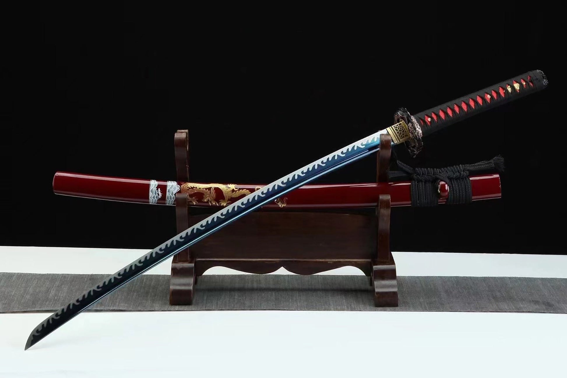 a sword with a wooden stand on a table