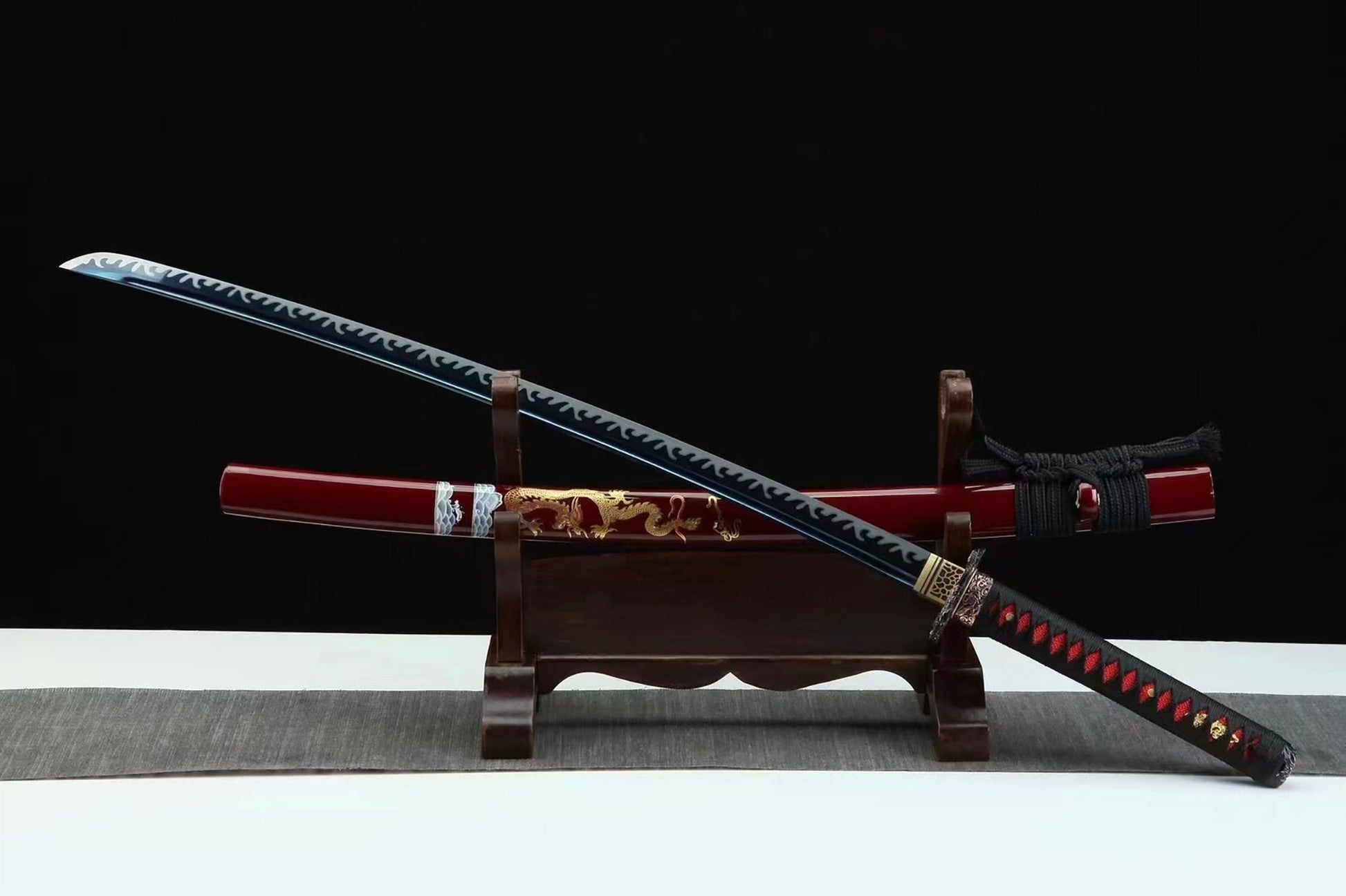 a red and black samurai sword on a stand