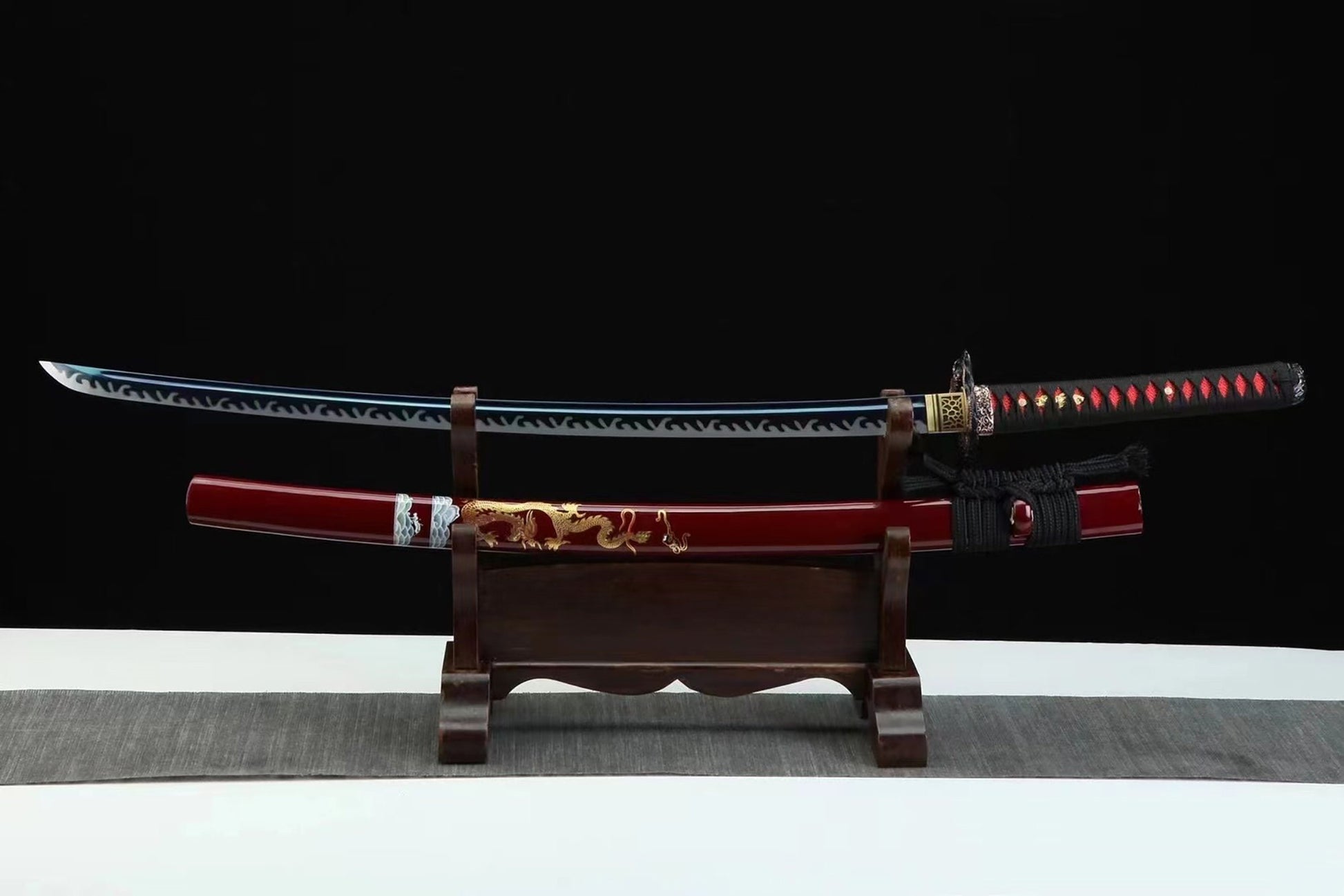 a wooden stand with a red and black sword on it